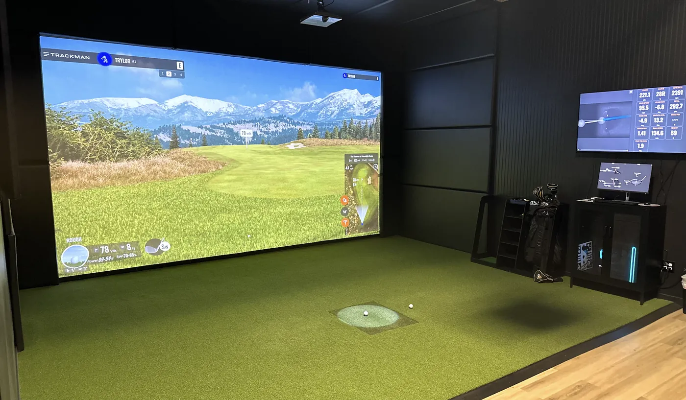 Bay 1 at Pin High Golf Suites: oversized ~18ft wide 4K TrackMan screen and hitting mat